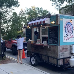 a woman ordering food from a food truck