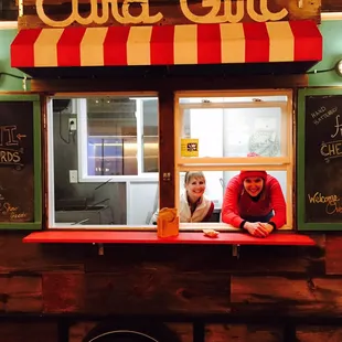 a man and a woman in front of a food truck