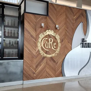 the entrance of a restaurant with a wooden wall