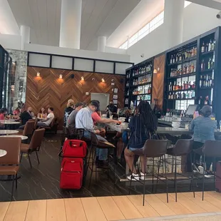 people sitting at tables in a restaurant