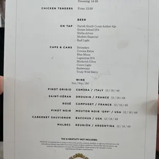 a person holding a menu in their hand