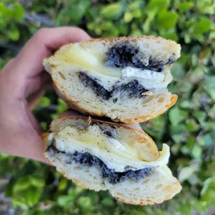 a person holding a half eaten sandwich