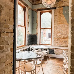 a dining room with exposed brick walls