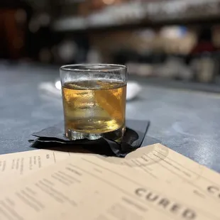 a glass of whiskey on a menu
