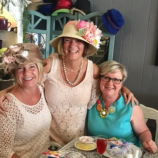 Friends celebrating s 50th birthday.  We all wore hats.  Heidi set the table with s Mad Hatter theme.