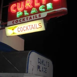 the neon sign for curly's place