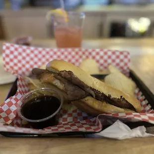 French Dip: Roast Beef and mozzarella cheese served on a hoagie roll with a side of Au Jus and Chips