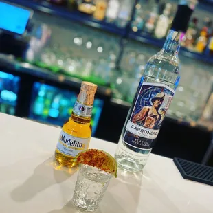 a bottle of vodka and a shot glass