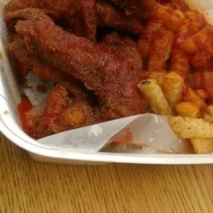 Close up of wings, French fries and ketchup