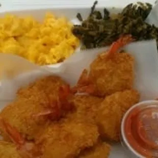 Big battered shrimp with cocktail sauce on the side, macaroni and cheese, collard greens