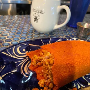 Veggie chorizo, egg, potato on red corn.