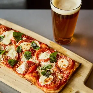 a pizza and a glass of beer