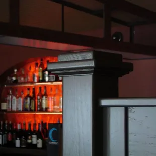 a view of a bar with bottles of alcohol