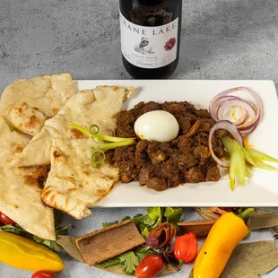 a plate of food and a bottle of wine