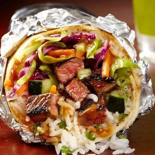 a burrito wrapped in aluminum foil