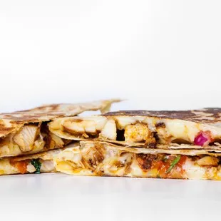 a stack of quesadillas with salsa