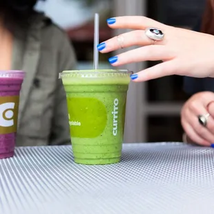 two people sitting at a table with drinks