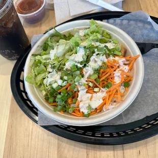 a bowl of salad and a drink