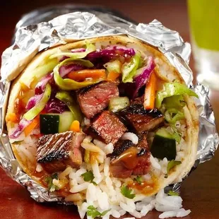 a burrito wrapped in aluminum foil