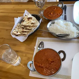 a wooden table with plates of food