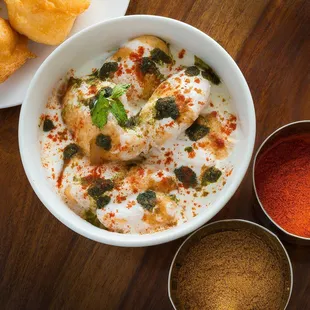 a bowl of curry and a plate of doughnuts