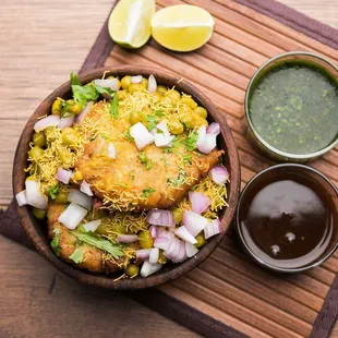 a bowl of food with a side of dipping sauce