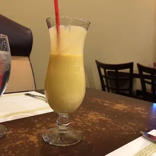 Tasty Mango Lassi on a very distasteful table - this dining room calls for a major renovation.