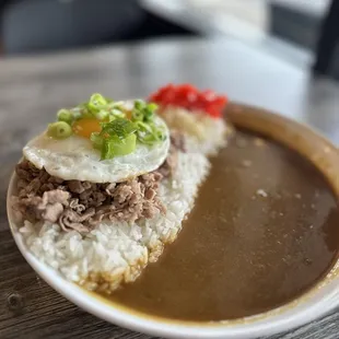 Curry over rice with beef belly and a friend egg