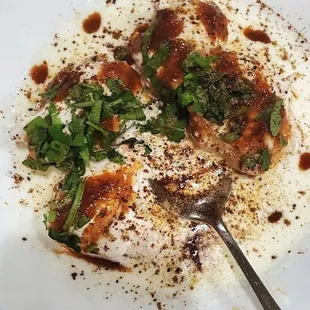 a plate of food with a spoon