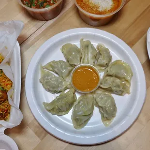 Momos! Handmade dumplings, veggie or chicken served with a slightly spicy coconut dipping sauce.