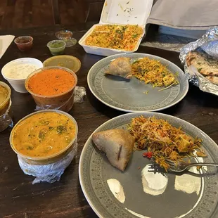 clockwise: Paneer Biryani, naan, Mushroom Matter, Aloo Gobi, a yogurt something, and Chicken Tikka Masala. Samosas on our plates.