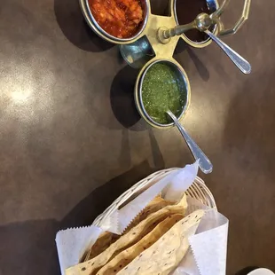 a tortilla, salsa, and condiments