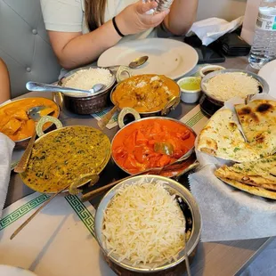Butter chicken, korma goat, spinach palak paneer, chicken tikka masala, and garlic naan