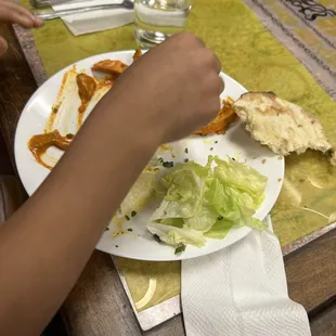 Other child&apos;s plate with butter chicken.