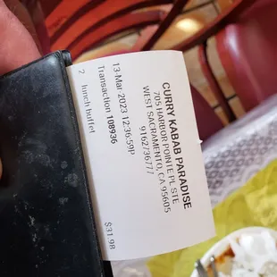 a hand holding a menu