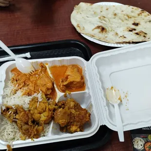 Chicken Tikka masala, rice, cauliflower and potato, naan, and samosa.