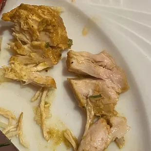 a white plate with chicken and rice