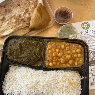 a tray of rice, beans, and naan bread