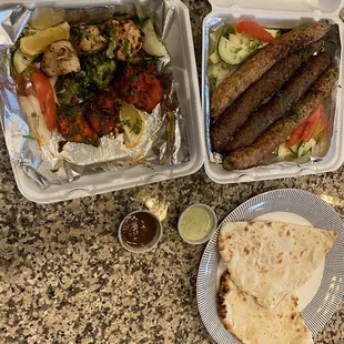 two trays of food on a granite countertop