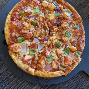 Half and half chicken and paneer deluxe pizza