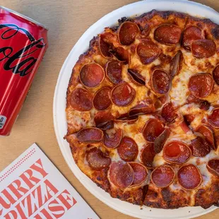 a can of coke and a pizza