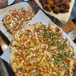 Wings: boneless tiki, achari, mango habanero, tandoori Large pizza: half aloo chat, half chicken tikka. Small: Butter chicken