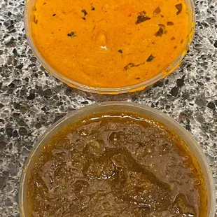 two bowls of curry on a granite countertop