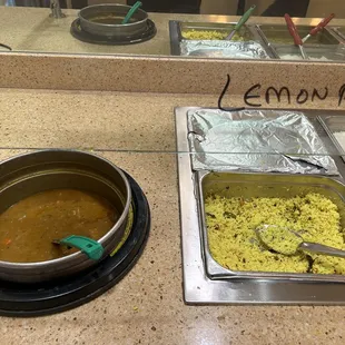 a bowl of rice and a pan of curry