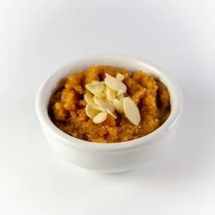 a bowl of curry with almonds on top