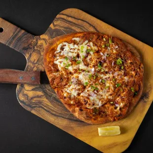 a pizza on a cutting board