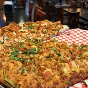 Large pizza 1/2 butter chicken and 1/2 tandoori chicken.