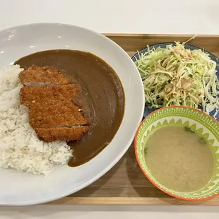 a plate of rice and a bowl of gravy