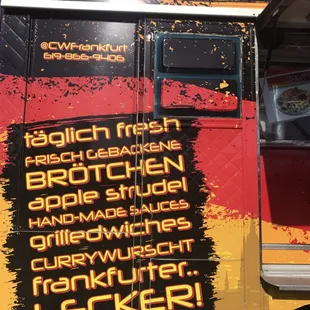 a food truck with a menu on the side