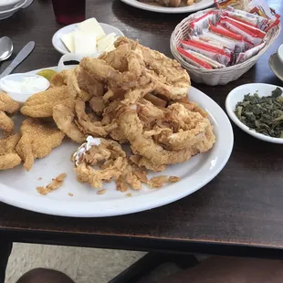 Catfish meal. It came with 5 pieces of catfish, a mountain of onion rings, coleslaw, collard greens, hush puppies and a dinner roll!!